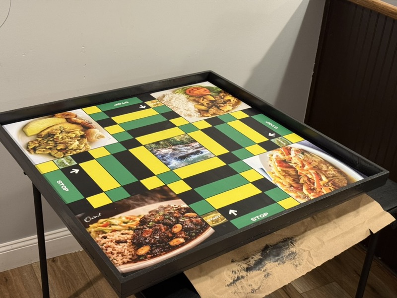 Jamaican food themed ludi board with ackee and saltfish, oxtail and curry corners